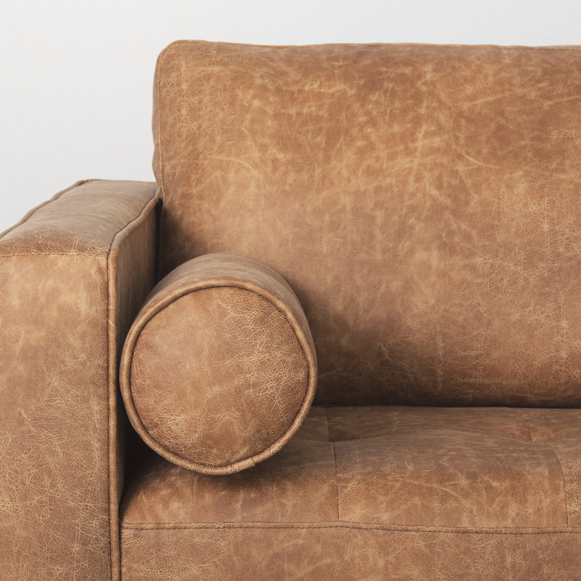 loretta 88.0l x 36.2w x 33.9h cognac brown faux leather three seater sofa with two bolster cushions