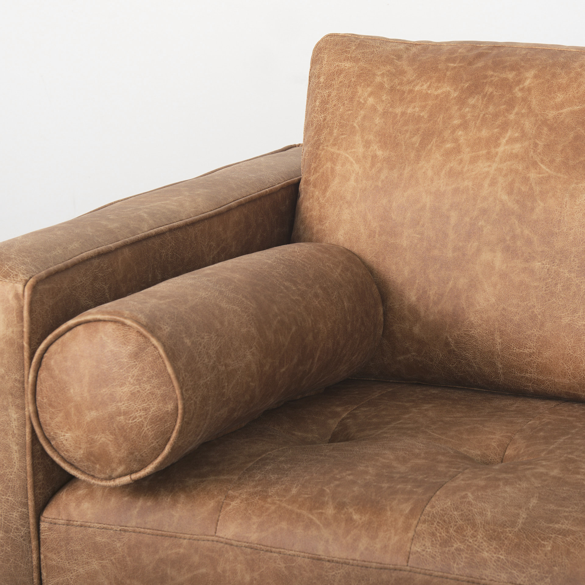 loretta 88.0l x 36.2w x 33.9h cognac brown faux leather three seater sofa with two bolster cushions
