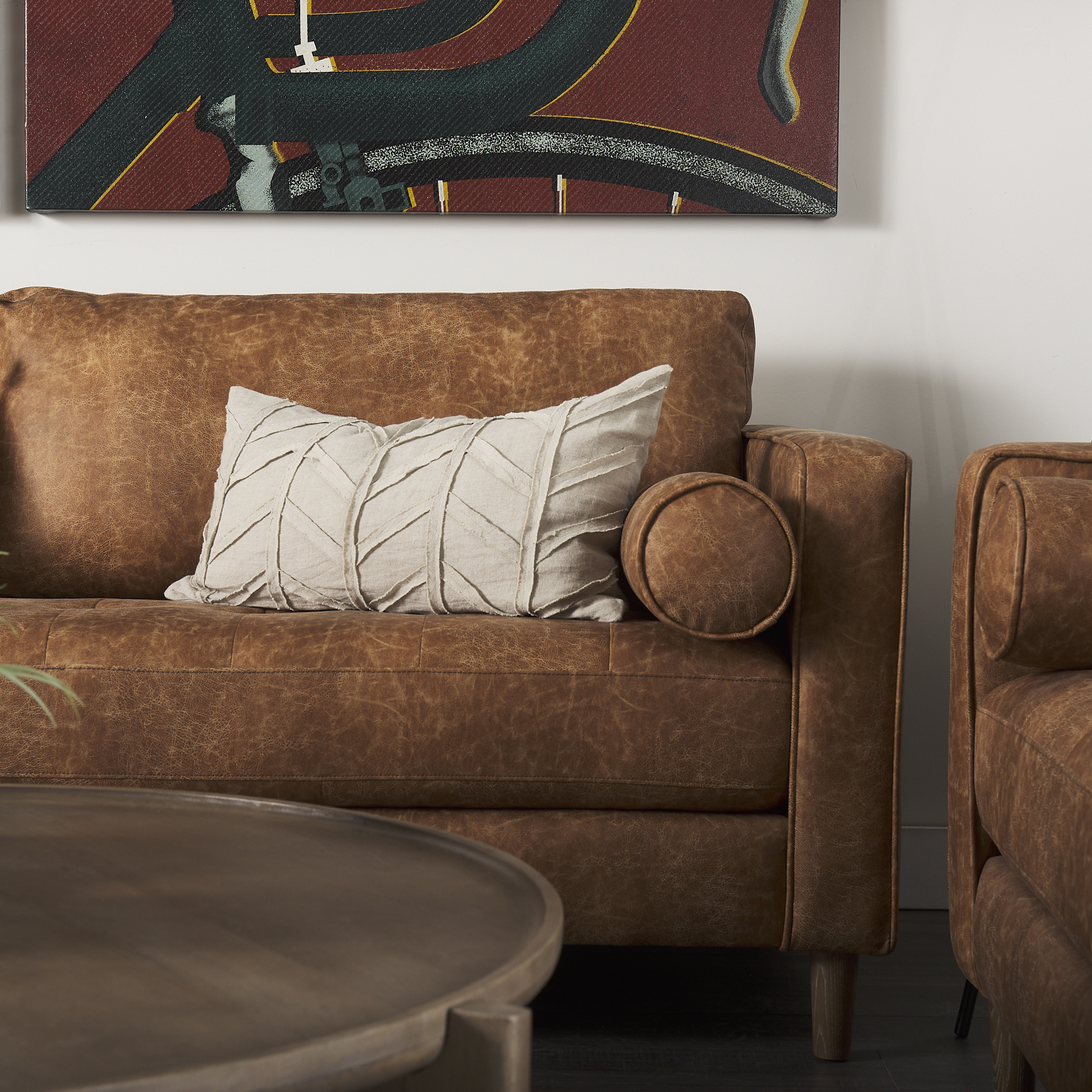 loretta 88.0l x 36.2w x 33.9h cognac brown faux leather three seater sofa with two bolster cushions