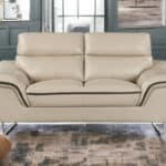 69 Inch Beige and Silver Faux Leather Love Seat with Pillow Arms