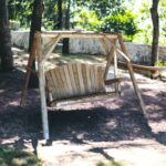 87" Natural Solid Wood Distressed Outdoor Swing Chair with Arms
