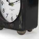 Karl 6.0L x 3.0W x 6.8H Rustic Black Iron Rounded Square Table Clock
