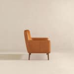 Tan Leather Mid-Century Modern Lounge Chair With Tapered Walnut Legs and Round Arms