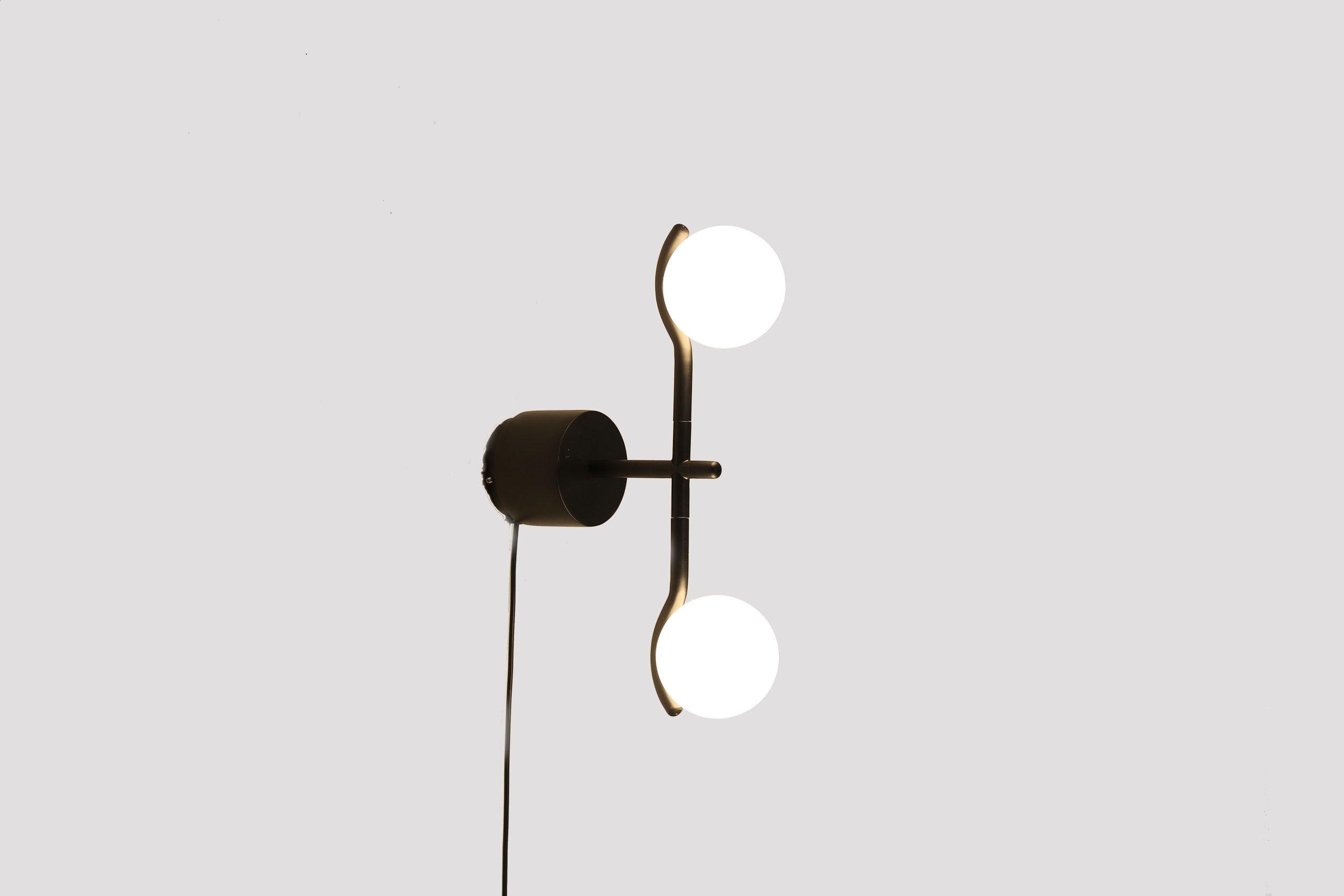 pluto black wall lamp with white glass